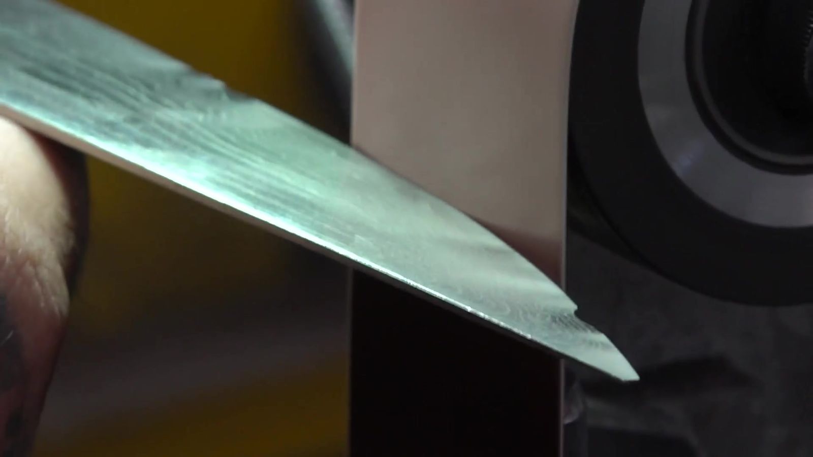 Close-up of a knife edge at the belt grinder